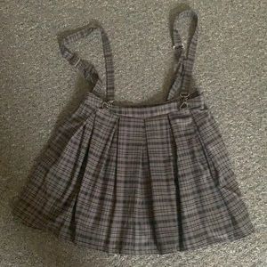 Pleated skirt with suspenders